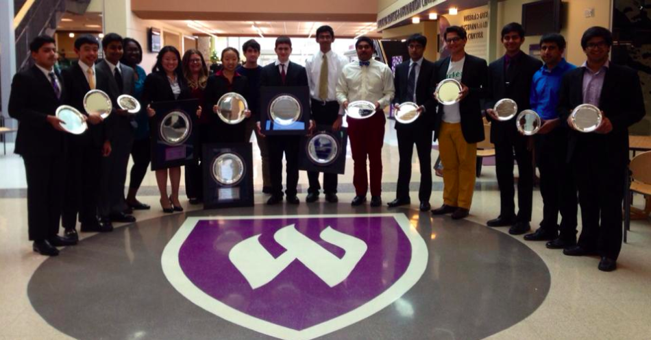 Winners at the national debate tournament hold up their awards in the halls of Weber University, where the Upper School debate team competed this past weekend. 