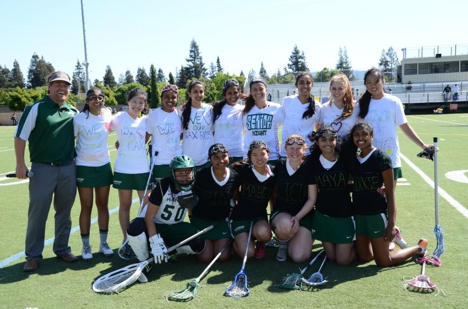 The girls Varsity lacrosse team poses for a picture in the Senior Night t-shirts prior to the game. The team celebrated its 7 seniors on Friday. 