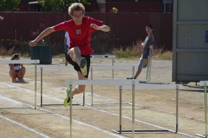 Calvin Kocienda (10) leaps over a hurdle during practice. The varsity track and field team had a record-breaking season this spring. 