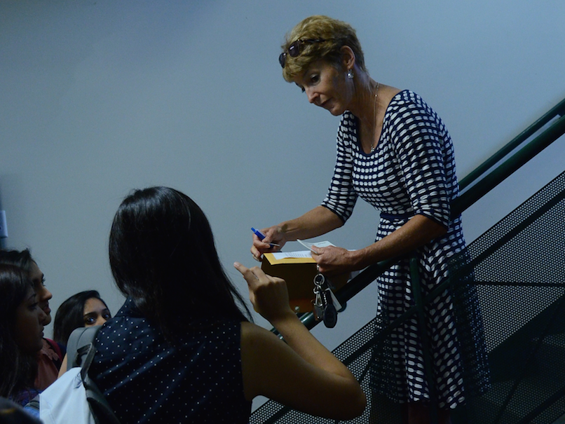In absence of senior advisor Andrew Irvine, senior Dean Diana Moss distributes the locker cards for his advisory. All seniors were assigned the same lockers as the previous year.
