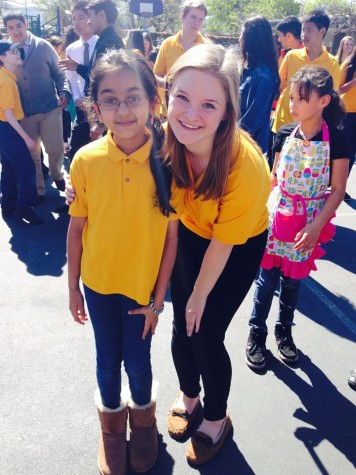 Darby Millard (12) and her fifth grade Eagle Buddy Minali Kapadia pose in matching yellow polos. The clever and "believable" I-swapped-my-Eagle-Buddy-polo-for-my-real-class-T-shirt will likely be pardoned with eye rolls and good-natured mockery, rather than a deeper questioning of how exactly you managed to confuse a shirt with a completely different texture, shade, and style with your real class T-shirt. 