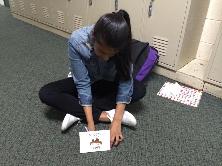 Anuva Mittal (10) writes a message in her Eagle Buddies card. The cards are supposed to be completed during this Thursdays advisory. 