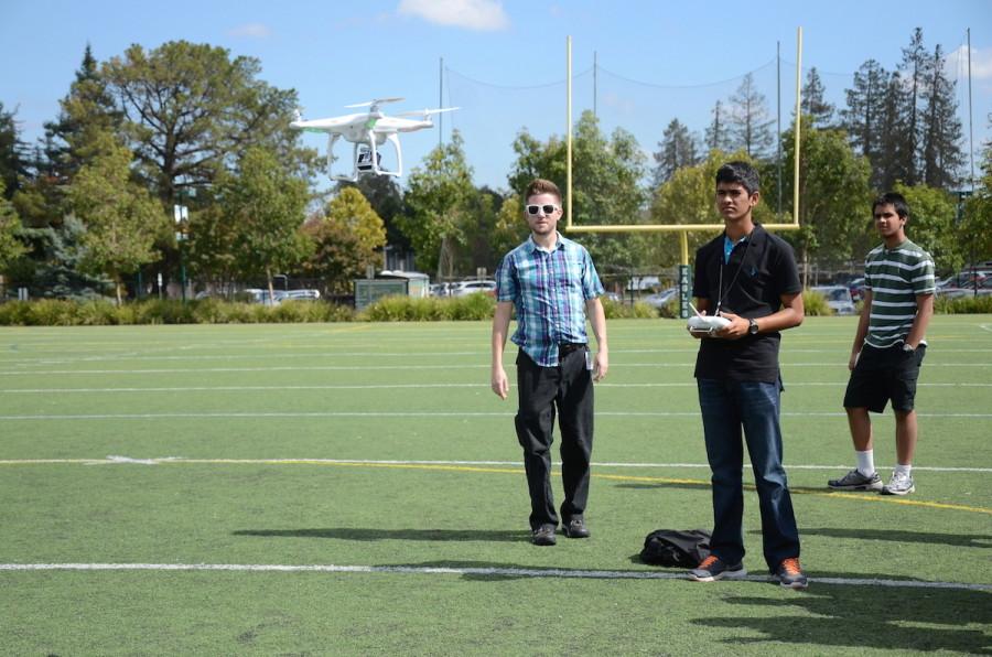 Aditya Varshney (11) flies the drone under the guidance of Eric Marten. The journalism students tested the drone for the first time today on Davis Field. 