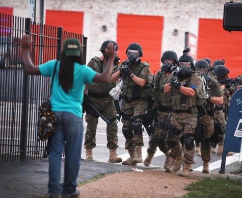 Police in retired Department of Defense (DoD) gear move through the Ferguson business district, forcing protesters to other neighborhoods. The Pentagons 1033 program, where any state or local law enforcement agency may request DoD equipment, faces intense scrutiny on Capitol Hill this week.