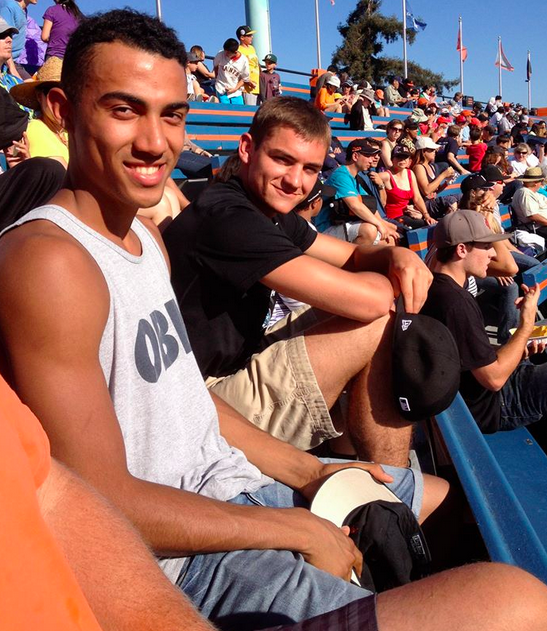 Elijah Edgehill (11) and Eric Holt (12) watch a San Jose Giants baseball game together. Elijah will stay with his host family, the Holts, for the duration of his stay at Harker.
