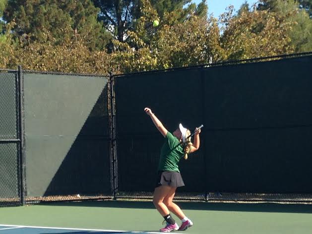 Elizabeth Schick (9) prepares to serve for the start of the match. She won 6-2 the first set and 6-1 in the second.