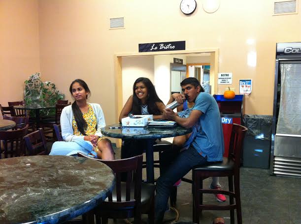 Juniors Amar Jain, Shreya Sankara and Aathira Menon watch the Giants game in the Bistro. The Giants defeated the Kansas City Royals 7-1 in the first game of the World Series.