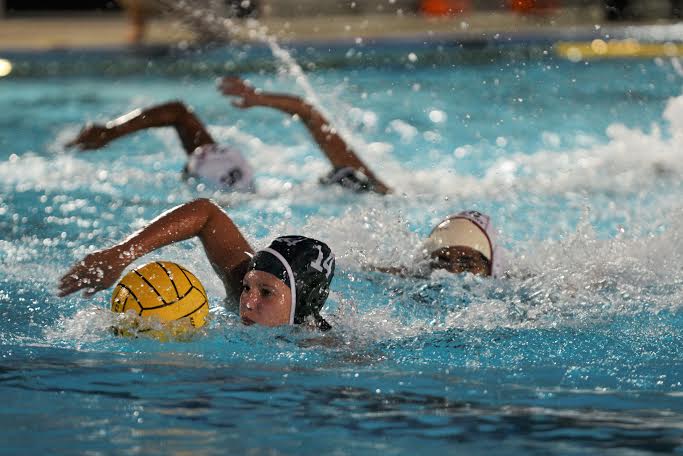 Emma Brezoczky (9) swims with the ball towards the goal. The girls won the game 10-9 vs. Fremont High School. 