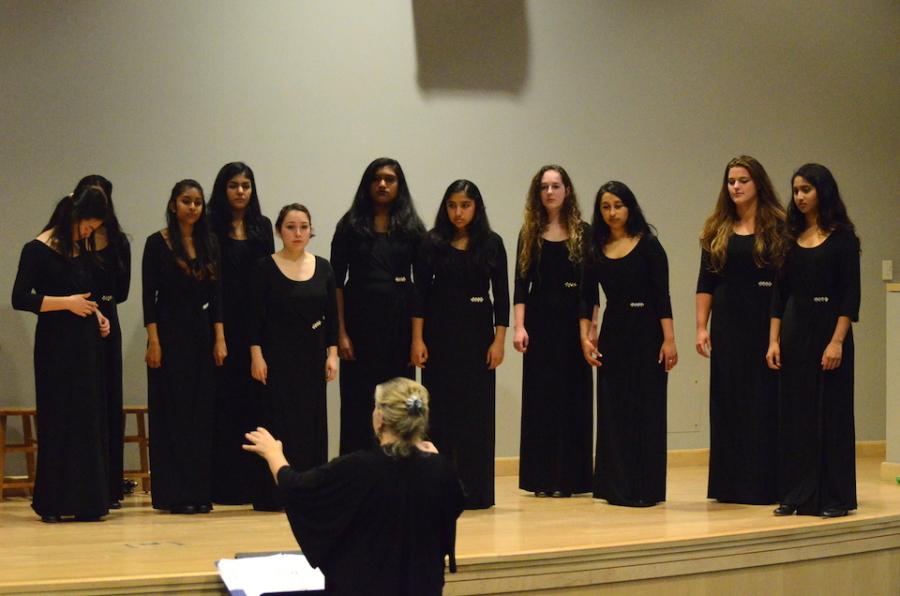 HOLY HARMONY: Cantilena sings their last song at the Choral Concert while being directed by Susan Nace. Several performing arts groups performed at the Choral Concert titled Ad Amore on Nov. 13 in Nichols Auditorium. 