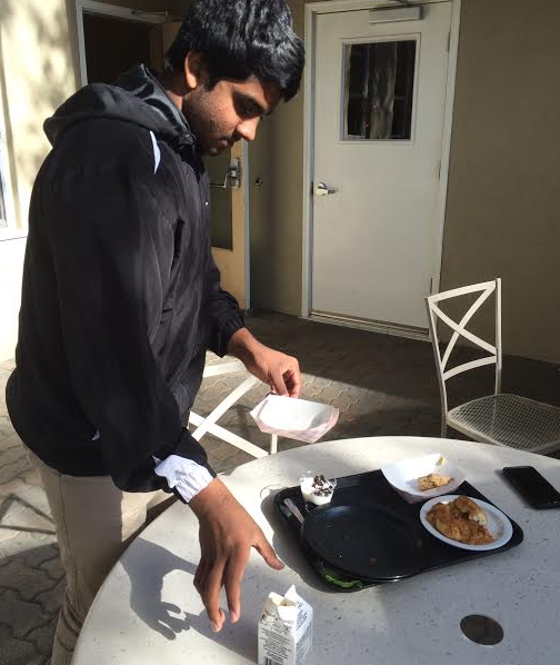 Arjun Ashok (12) cleans up left over trash after 6th period today. Student Council is working to eradicate the current trash situation.