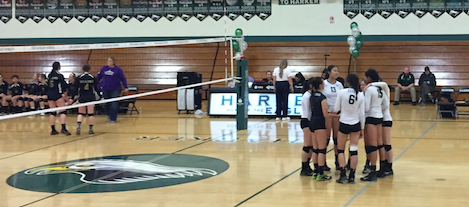 The Varsity girls volleyball team huddles together before the final set. The girls defeated Willows High School 3-0 to advance to the second round of the Norcal tournament.