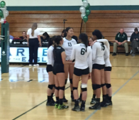 Members of the Varsity girls volleyball team huddle together before the start of the third set. The girls beat Willows High School 3-0 to advance to the second round of the Norcal tournament.