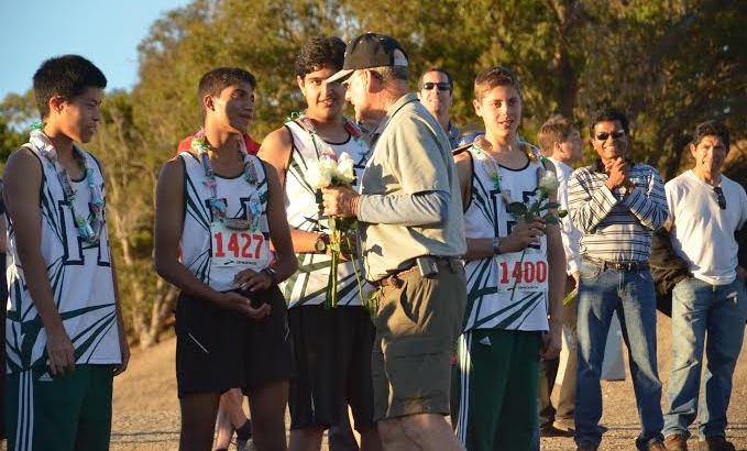 Vivek Sriram (12) and Coach Scott Chisam exchange words as the seniors are honored at a ceremony with all the other teams. This was the last race of their high school cross country careers for most of the seniors.