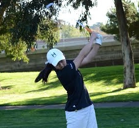 Katherine Zhu (9) takes a hard practice swing before readying herself for the real one.