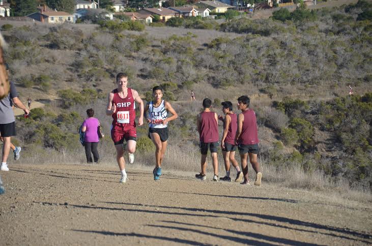 Corey Gonzales (12) runs neck in neck with Daniel Hill from Sacred Heart Prep on senior night. The two finished 10 seconds apart, and 30 seconds apart from the next fastest runner.