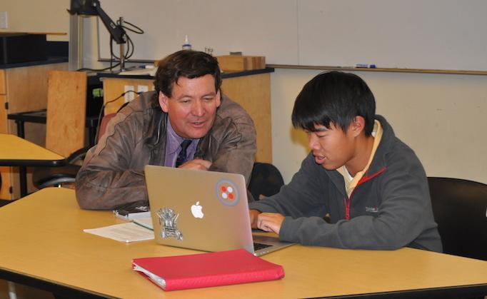 CONFERRING TO HELP: Dr. Eric Nelson works with Johnny Trinh (11), helping him solve problems and talking about parent-teacher conferences. Parent-teacher conferences are set for next week during Thanksgiving break. 