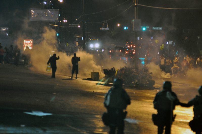 Law enforcement uses tear gas on protesters during the first wave of unrest on Aug. 17. After the fatal shooting of Michael Brown on Aug. 9, protesters took to the streets across the nation, sparking a national conversation about police brutality and lethal force.