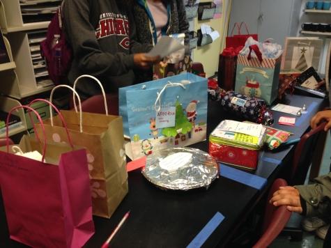 Students pick their Secret Santa presents from a table in the back of the journalism room. This week, many organizations on campus are participating in the Secret Santa gift exchange. 