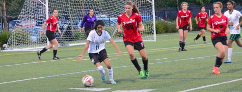 Nikita Parulkar (12) dribbles the ball away from her opponent. The girls' varsity soccer team loses against Fremont High School 3-4.