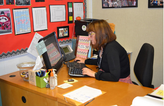 The attendance coordinator, Sue Prutton works at her desk. Tardies and absences have many consequences for students when appearing in multitudes.
