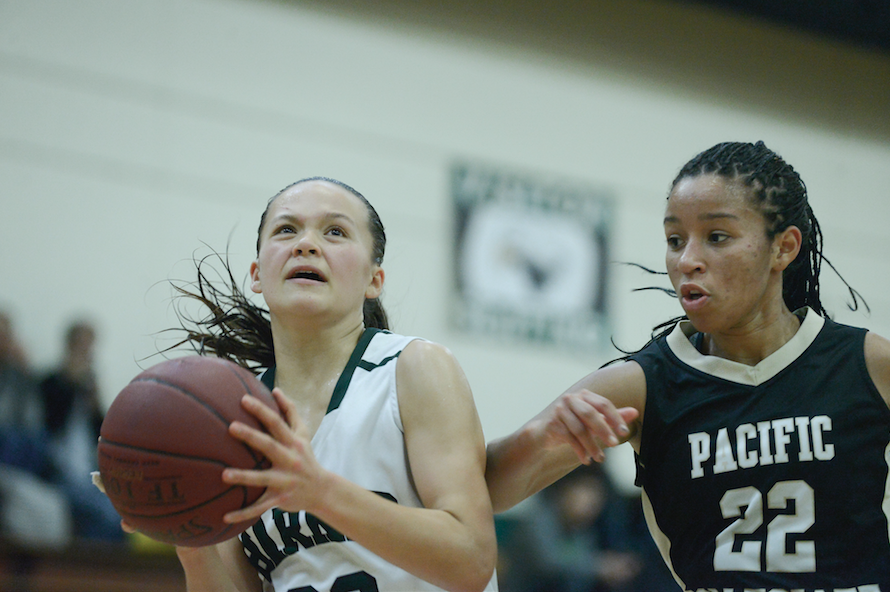 Jordan Thompson (10) tries to avoid a defender. The Varsity girls basketball team defeated Pacific Collegiate 39-20.