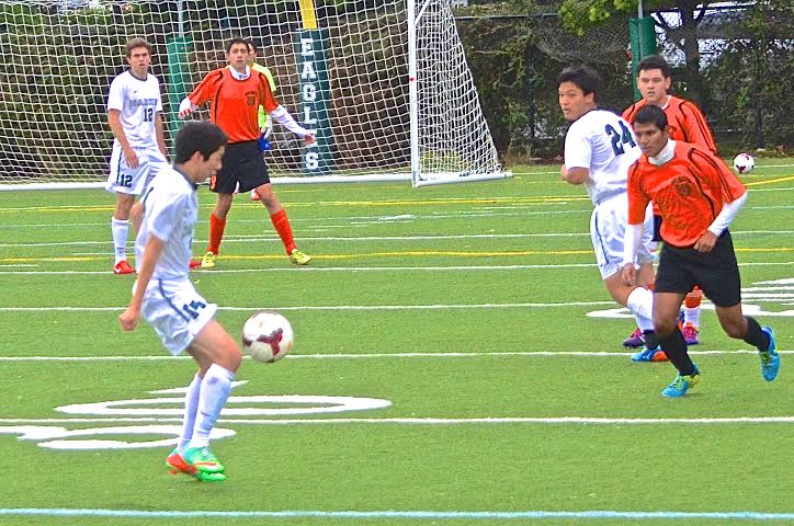 Eric Roxlo (12) dribbles the ball towards a defender. The Eagles beat San Mateo High School 5-2 in the third game of the season.