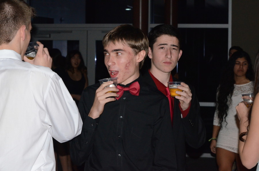 Zarek Drozda (11) and Jonathan Hochberg (11) chat with friends while drinking apple cider. The Winter Ball took place in Nichols Hall on Saturday, Jan. 17.
