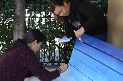 Alexa Gross (10) and Shreya Basu (12) work on the bench. They collaborate in continuing on what had been painted before.
