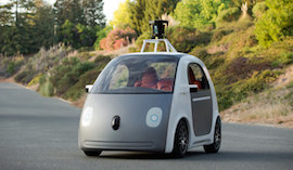 Google’s new driverless car cruises through the streets, using the sensor array mounted on the roof to steer.  The car is equipped with manual controls to comply with California state law.