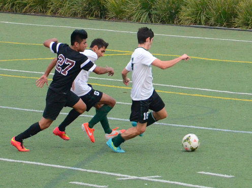 Ramzi Jahshan (12) and Sharad Chandra (9) defend the ball from an Eastside player. The boys varsity soccer team defeated Eastside 2-0.