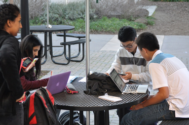 Victor Shin (9) and Brandon Mo (9) discuss homework at a table in front of Manzanita Hall. Students start the second semester off strong by working hard.