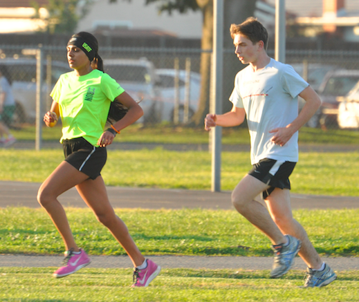 Niki Iyer (10) and Jack Rothschild (11) run laps around the Blackford field as a part of their preseason conditioning. Track and Field practice will begin on Feb. 2 at Blackford. 
