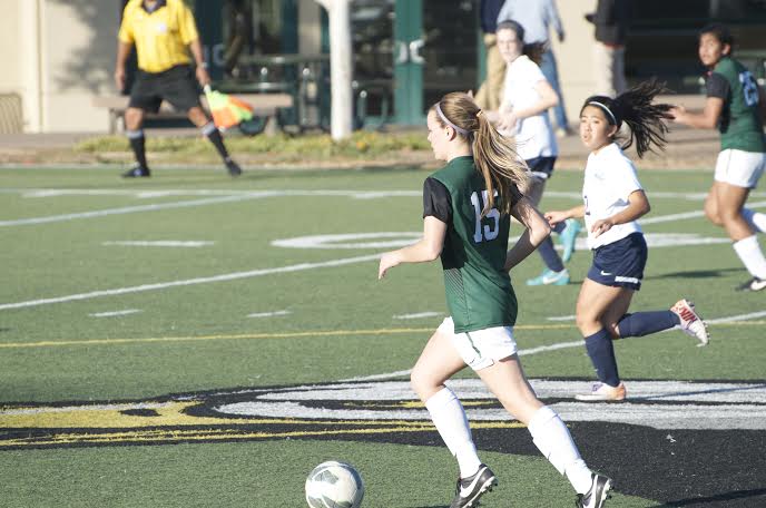 Alyssa Amick (12) runs down the field with the ball. The girls went on to a 6-0 victory over Mercy Burlingame.