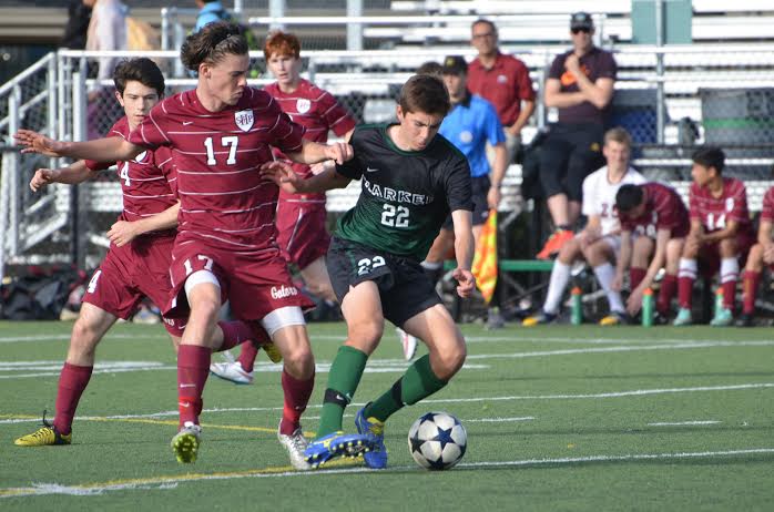 Jeremiah Anderson (12) dribbles the ball away from a defender. The boys lost 0-5 yesterday.