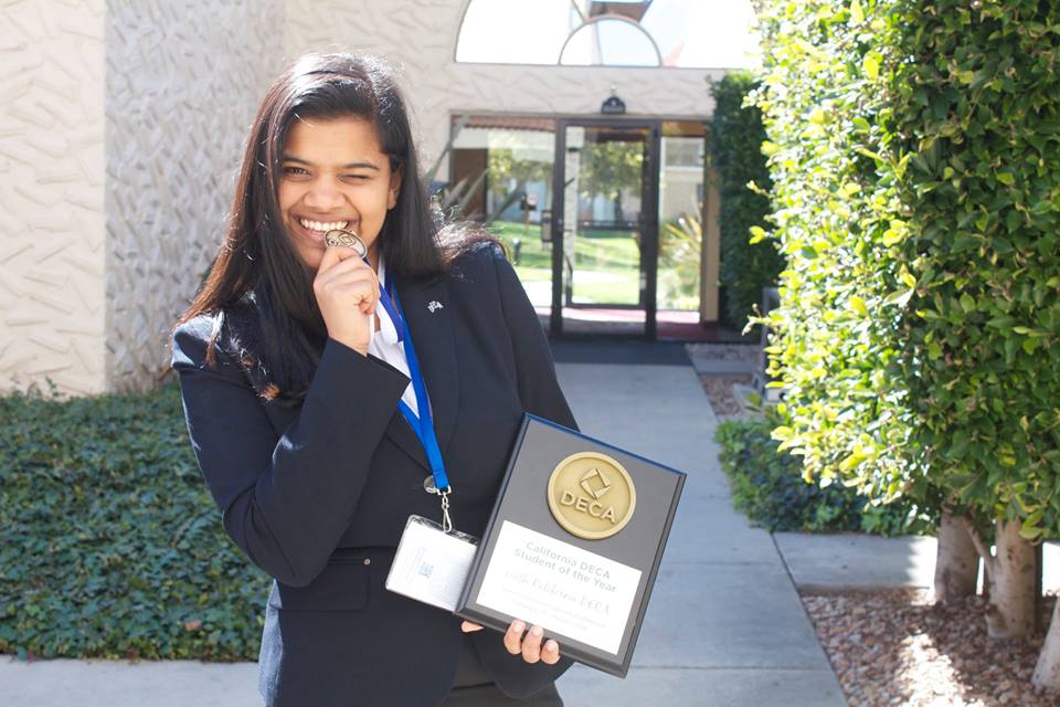Savi Joshi poses with her plaque and medal at the California Career Development Conference. Savi won California DECA Student of the Year at the conference.