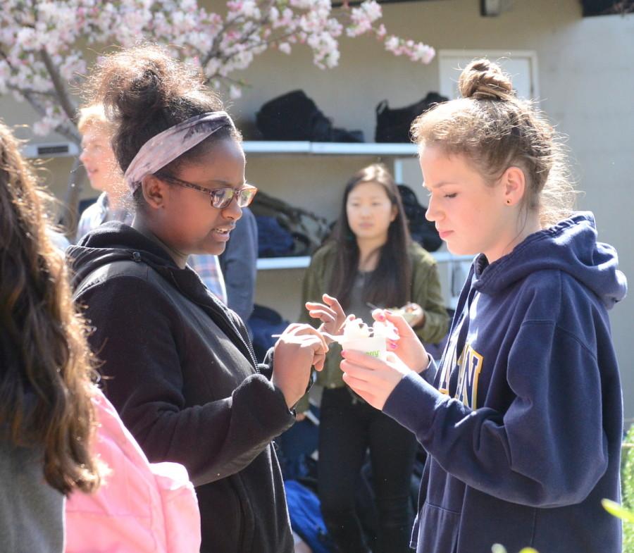 Mahlet Demi (10) and Lauren Napier (9) share a cup of Pinkberry outside of Manzanita during long lunch. The proceeds made from this fundraiser will be donated to the Adopt a Village program from an organization called Free the Children.