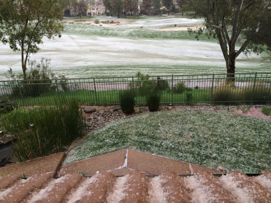 Sheets of hail cover the Silver Creek golf course. This is an atypical view of the golf course, which usually looks a dark green.