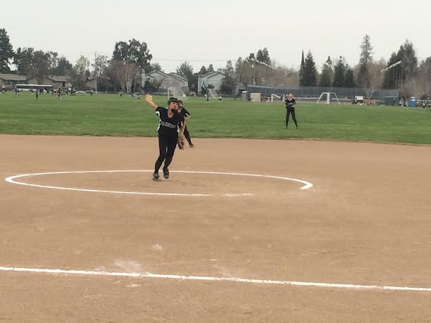 Kristin LeBlanc (9) pitches the ball while playing outfield in the softball match against Mercy Burlingame. Leblanc pitched for the entire match.