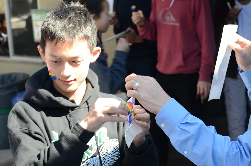 Freshman Justin Su wears pride stickers given out during the GSA fundraiser this week. GSA also sold food and hosted a salsa dancing event during their club week.