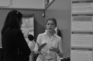 Nastya Grebin (9) explains her research project at the research symposium. She conducted her research with her partner, Anooshree Sengupta (9).