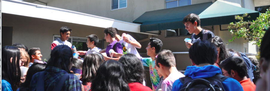 Students reach for snow cones after school. Spirit Club handed out free food to students every day after school.