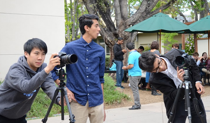 Jonathan Dai (11), Ankur Karwal (11), and Shay Lari-Hosain (11) set up cameras to film. Multimedia Club produces videos for many clubs across campus.