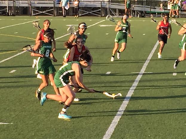Priscilla Pan (12) picks up the dropped ball and runs down the field to Aragons goal. Priscilla has been a member of the Harker lacrosse team for 2 years. 
