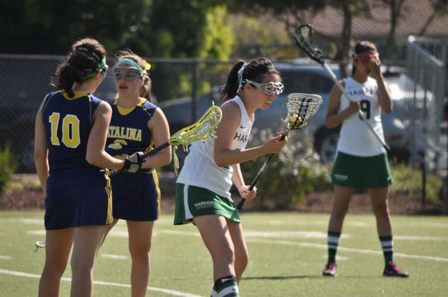 Priscilla Pan (12) cradles the  the ball during Varsity Lacrosses game against Santa Catalina. They won 20-5.