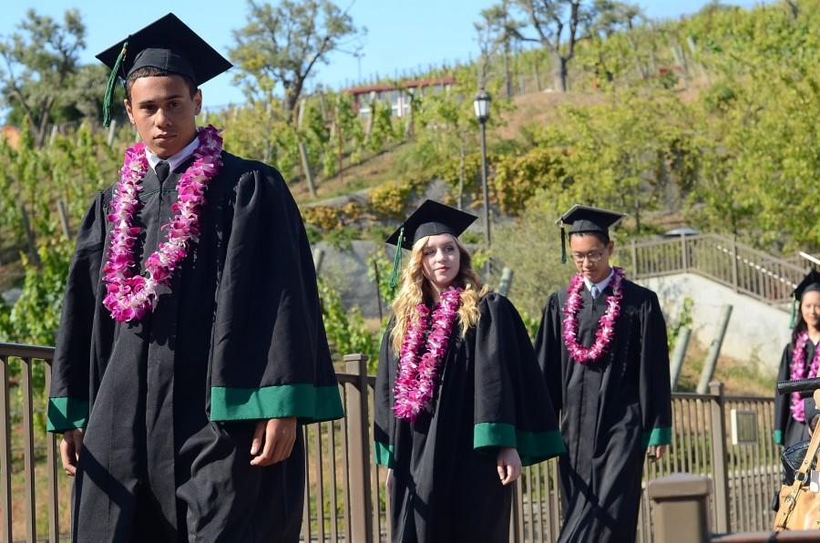 Christian Williams (15), Zoe Woehrmann (15) and Felix Wu (15) make their way down to their seats at the bottom of the stage at the beginning of the ceremony. The graduation ceremony took place today at the Saratoga mountain winery.