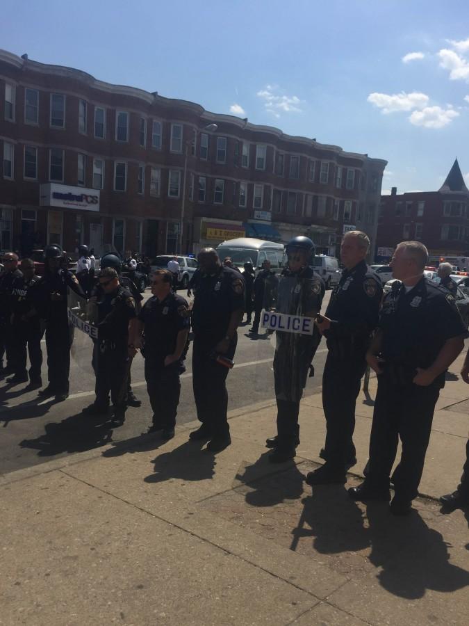 Police officers line up across the street during a protest at Baltimore. Six officers were charged in the death of Freddie Gray on May 1.