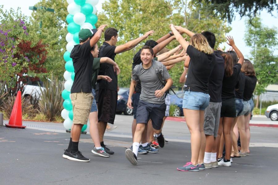 Cheering Key Club members introduce the class of 2019 through a tunnel of hands. Freshmen Orientation was held on Aug. 20. 