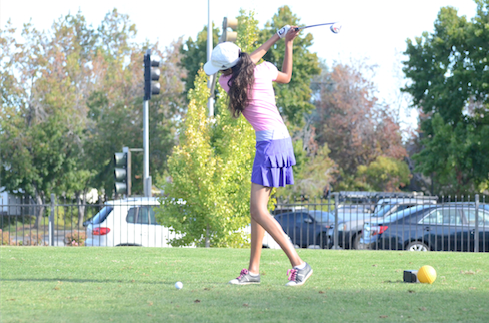 Alexis Gauba (11) finishes her swing during girls golf practice.
