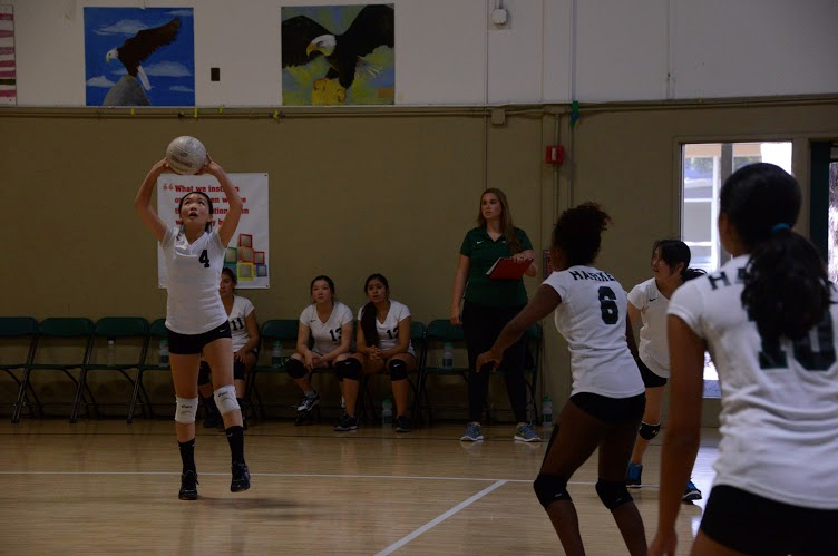 Connie Xu (9) sets the ball during the match. The girls went on to lose the game 0-2.