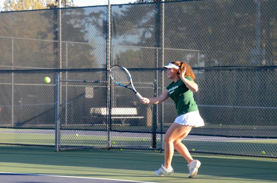 Izzy+Gross+%2812%29+hits+the+ball+over+the+net.+Izzy+plays+number+one+doubles+for+the+team%2C+along+with+Karina+Butani+%2810%29.+The+final+score+was+7-0.+